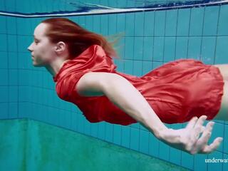 Red long dress and big tits floating in the pool